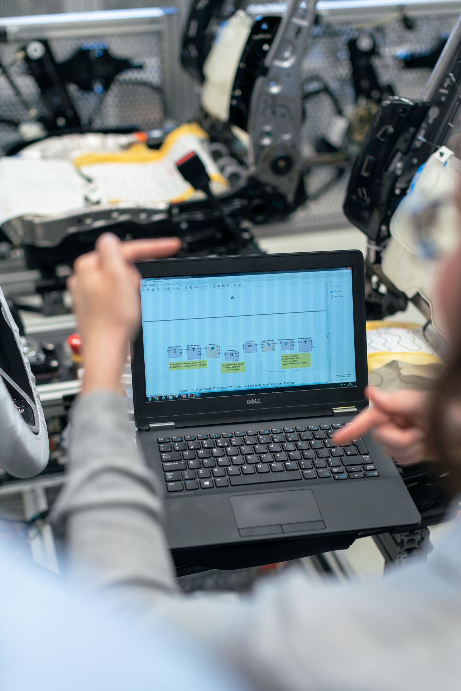 Engineer reviewing operations data on a laptop in a facility